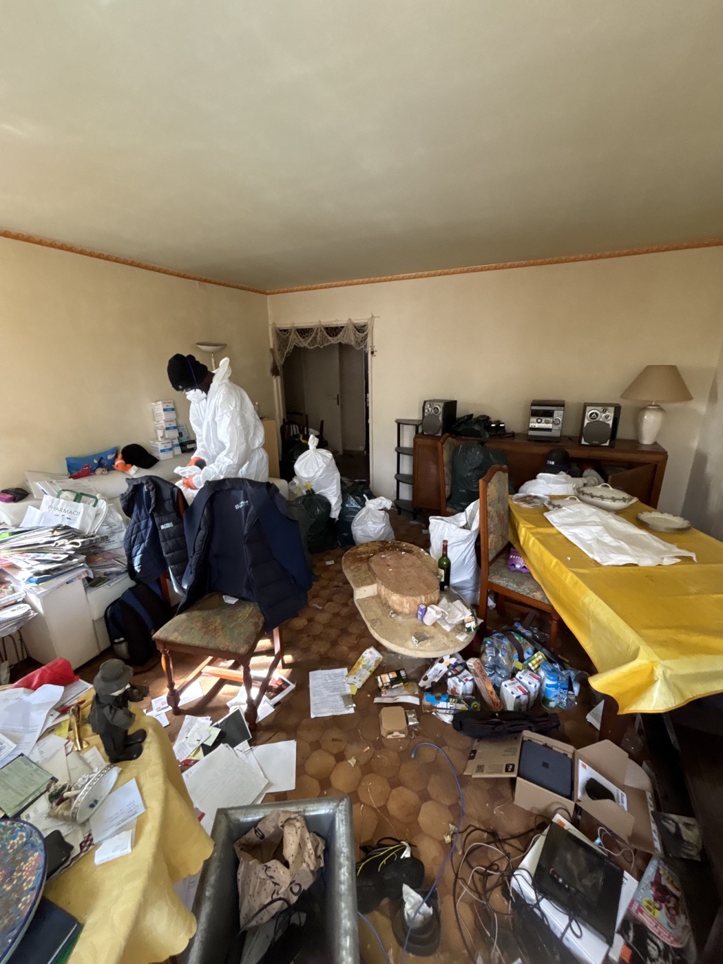 Équipe protégée réalisant le tri dans un logement encombré